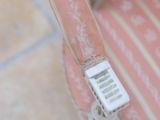 a remote control sitting on top of a pink chair