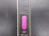 packaging of a pink vibrating device on a black background