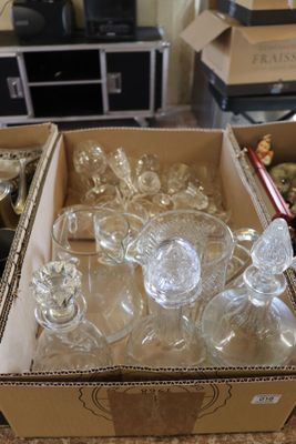 a box full of empty glassware on a counter
