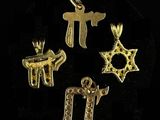 a group of gold charms including a star of david, a star of david, and a star of david