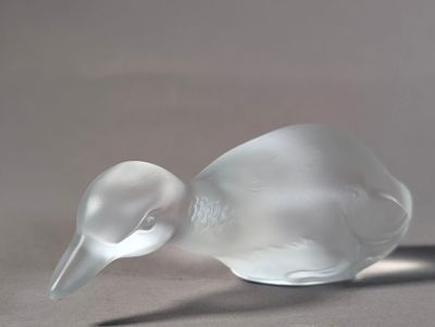 a glass bird that is sitting on a table