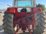 an image of a red tractor parked on the side of the road