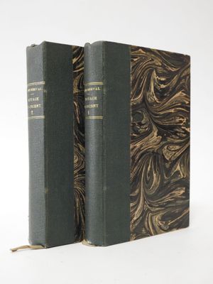 two books sitting on top of each other on a white surface