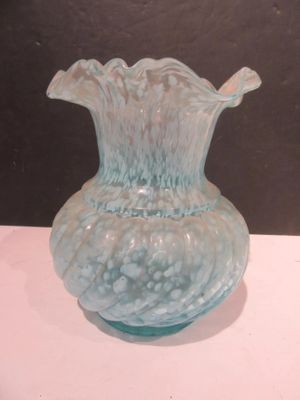 a glass vase that is sitting on a table