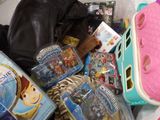 a pile of children ' s toys and toys on a bed