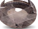 a cat that is wrapped in plastic on a white surface