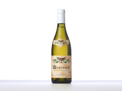 a bottle of white wine sitting on top of a table