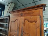 a large wooden cabinet with a mirror on top of it