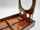 a wooden box with a mirror on top of it