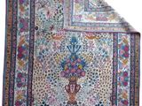 a close up of a rug with a vase on it