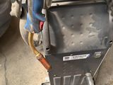 a close up of a car ' s air conditioner with a hose attached to it