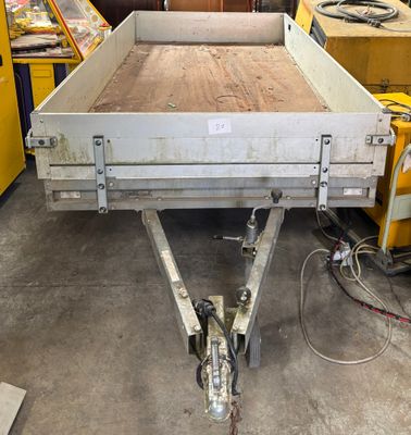 a trailer with a flat bed in a warehouse