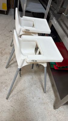 three white chairs and a table in a kitchen