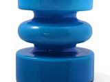 the large blue vase is sitting on top of a white table