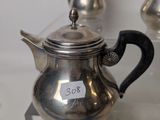a silver tea pot and a silver tea pot on display