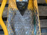 a close up of a yellow and black motorcycle on a pallet