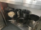 many pots and pans that are on the counter