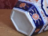 a blue and white vase sitting on a wooden table