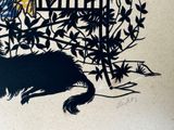 a black and white drawing of a cat and a bird