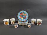 many cups and saucers that are sitting on a table