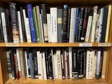 a book shelf with many books on it in a room