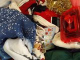 a pile of clothes that is sitting on a bed