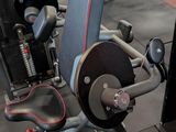 a gym room with a bench, weights, and other equipment
