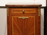 a wooden cabinet with a marble top on display