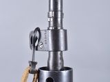 a close up of a metal device with a wooden handle