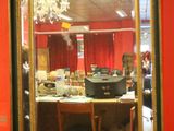 a mirror hanging on a red wall in a room