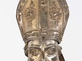 silver statue of a man with a beard and a hat on
