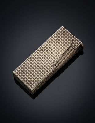 a silver cigarette case on a black background