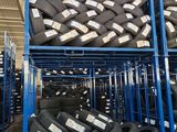 a lot of tires that are stacked up in a warehouse