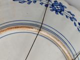 a blue and white plate with a clock on it