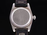 a close up of a watch on a black background