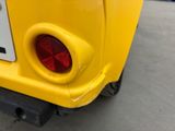 a close up of the rear end of a yellow car