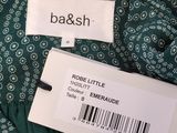 a close up of a label on a green dress