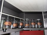many jars on the shelf in the kitchen