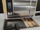 a stainless steel oven that is sitting on the floor