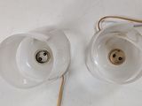 two lamps that are sitting on a white table