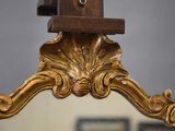 a mirror that has a birdhouse on top of it