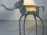 a statue of an elephant with a gold cloth on it ' s back