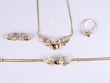 three pieces of jewelry including a necklace, bracelet, and ring