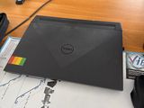 a laptop computer sitting on a desk in front of a computer monitor