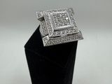 a close up of a diamond ring on a black stand