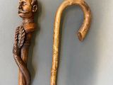 a wooden walking stick with a monkey head on it