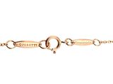 a close up of a gold chain with a name on it