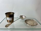 a glass table with a silver spoon and a cup on it