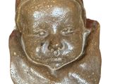 a small figurine of a baby with a name tag