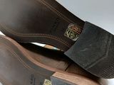 pair of men ' s brown leather shoes on a white surface